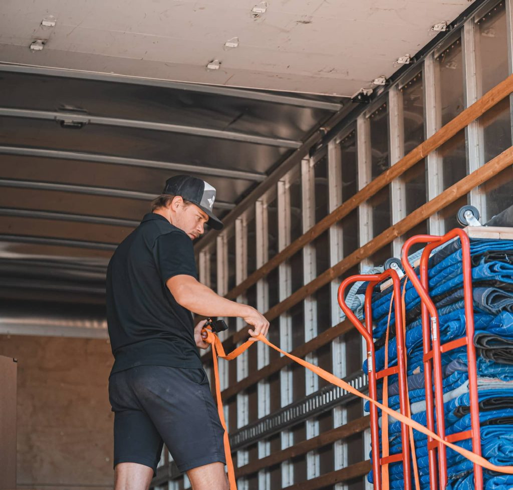 Worker securing items inside moving truck