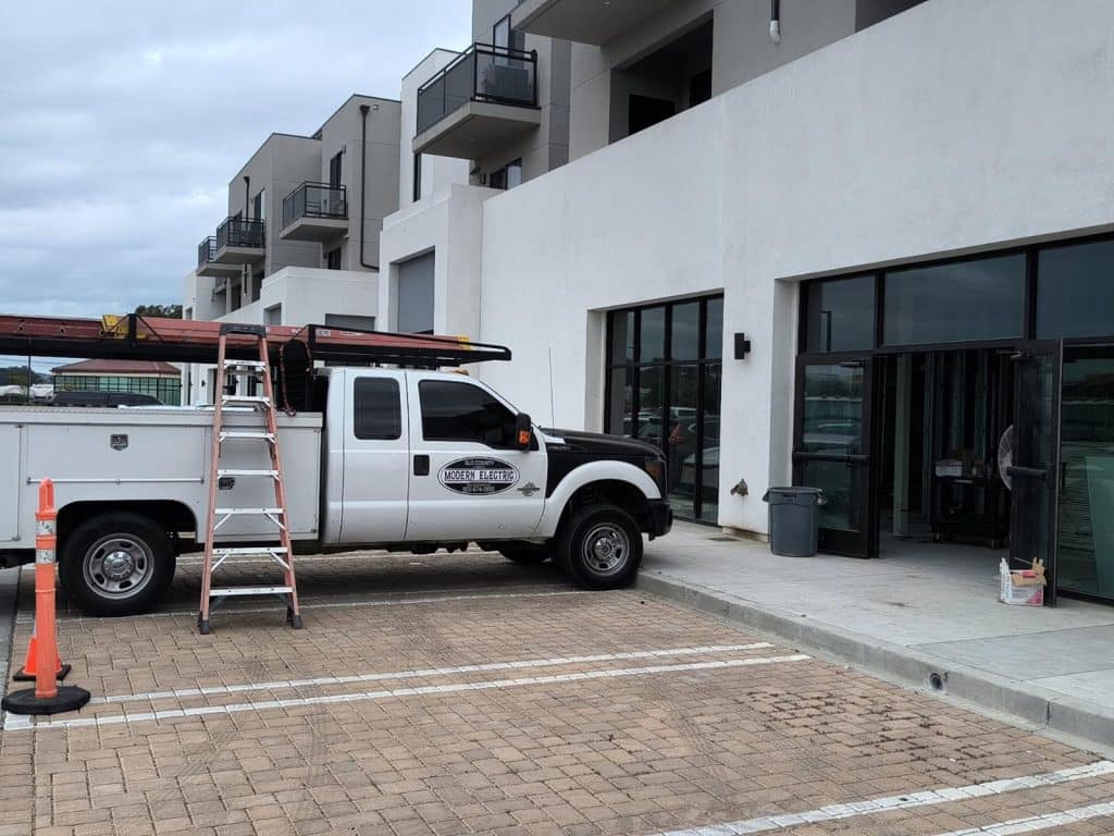 Electrician truck parked outside commercial building