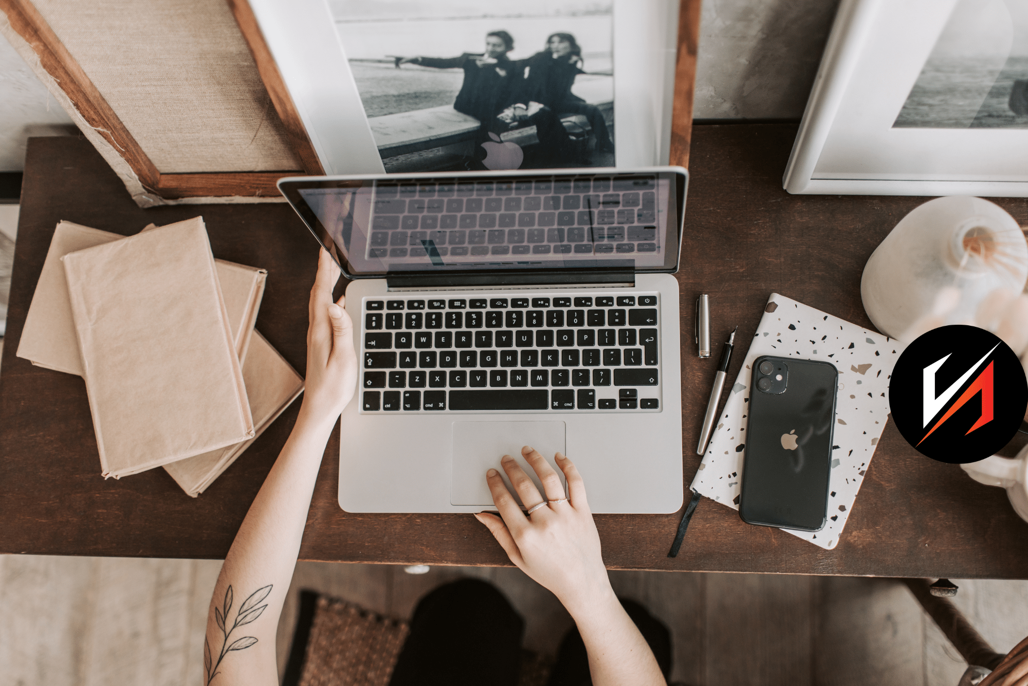 Person working on laptop at wooden desk