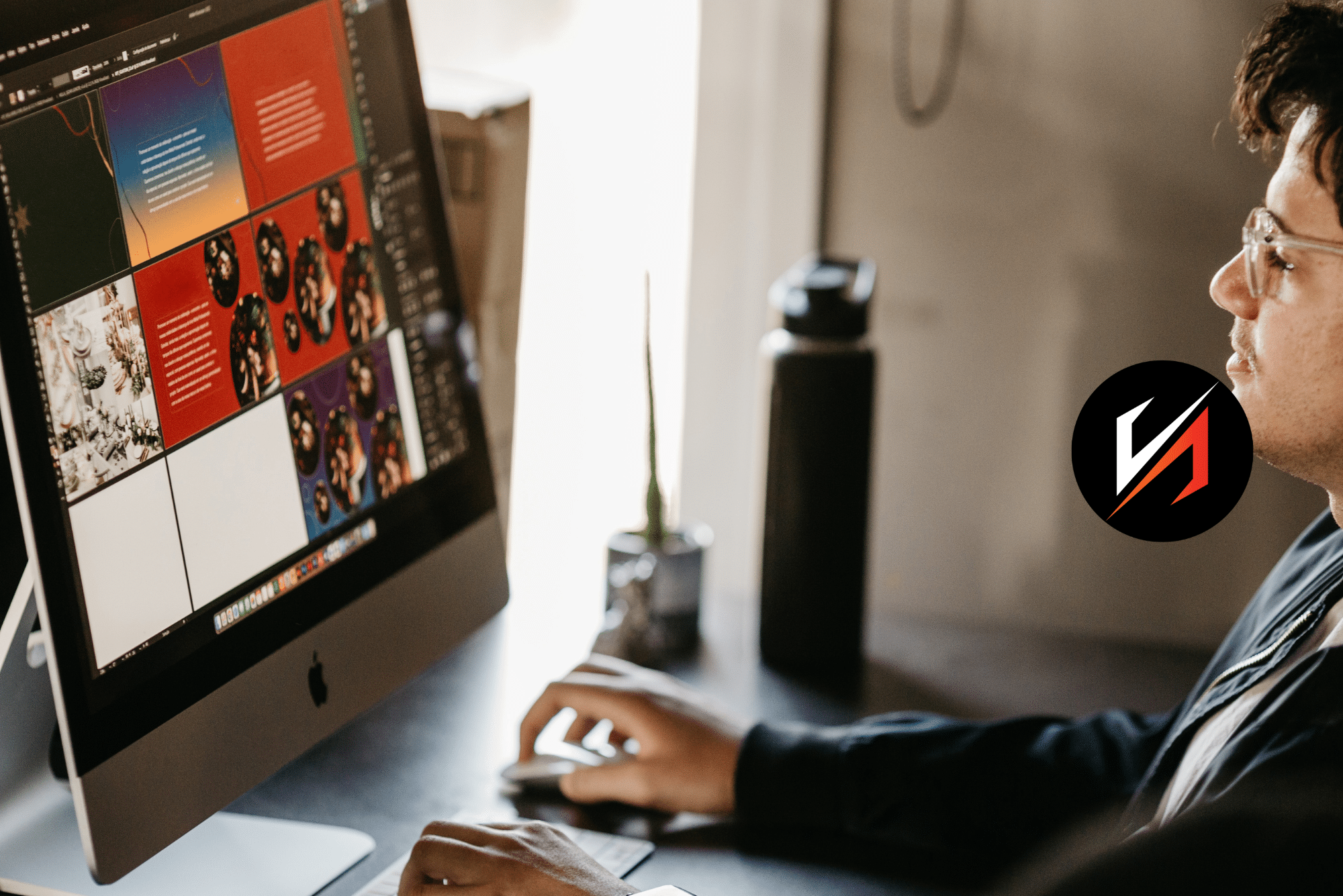 Designer working on colorful layout at desktop computer